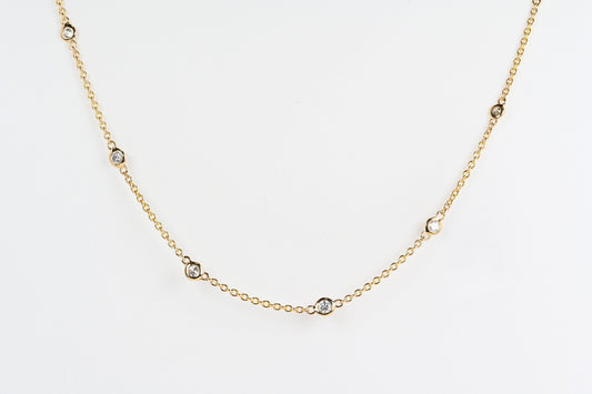 Nine shiny diamonds bezel set on a fine gold chain