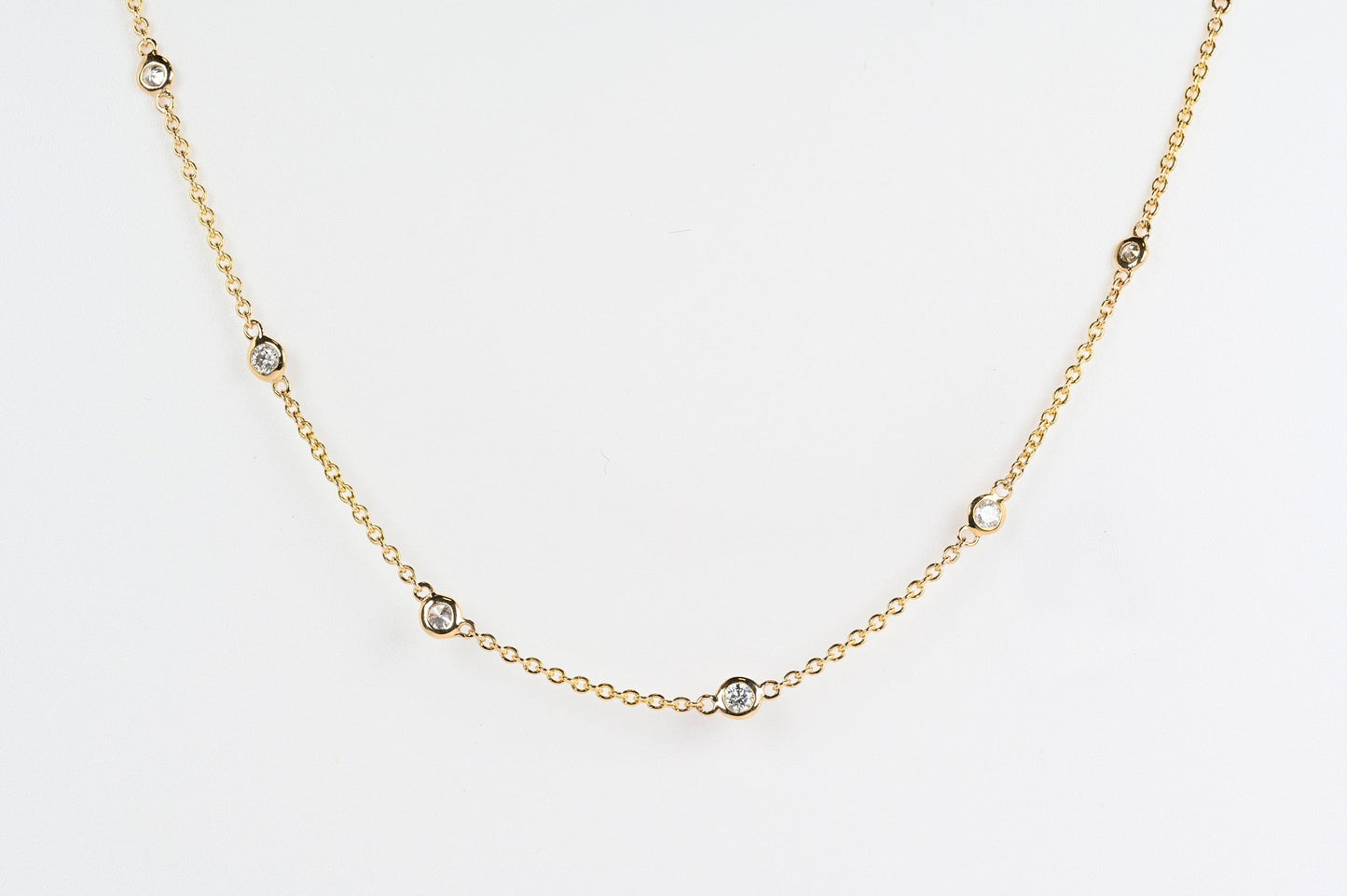 Nine shiny diamonds bezel set on a fine gold chain